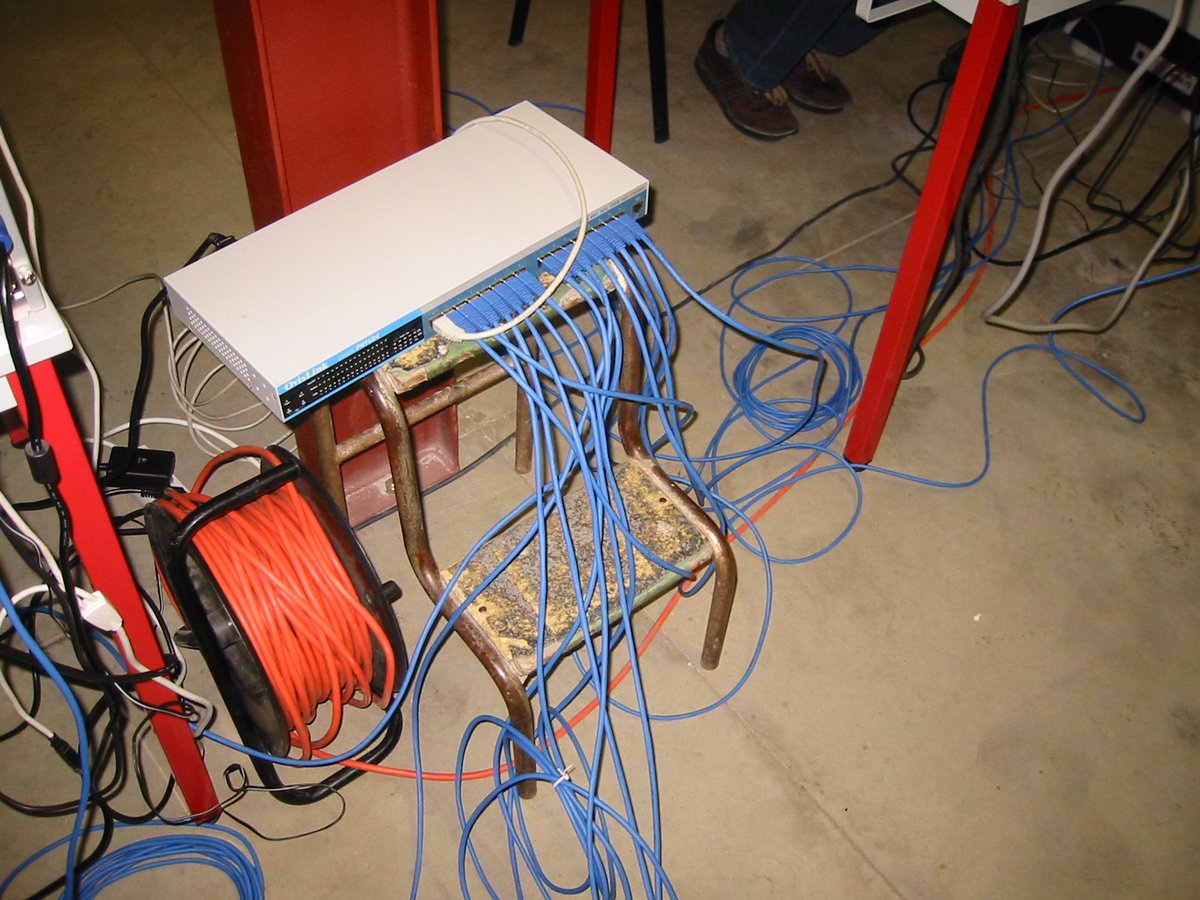Players with desktop PCs and CRT monitors at a LAN party in France in 2003