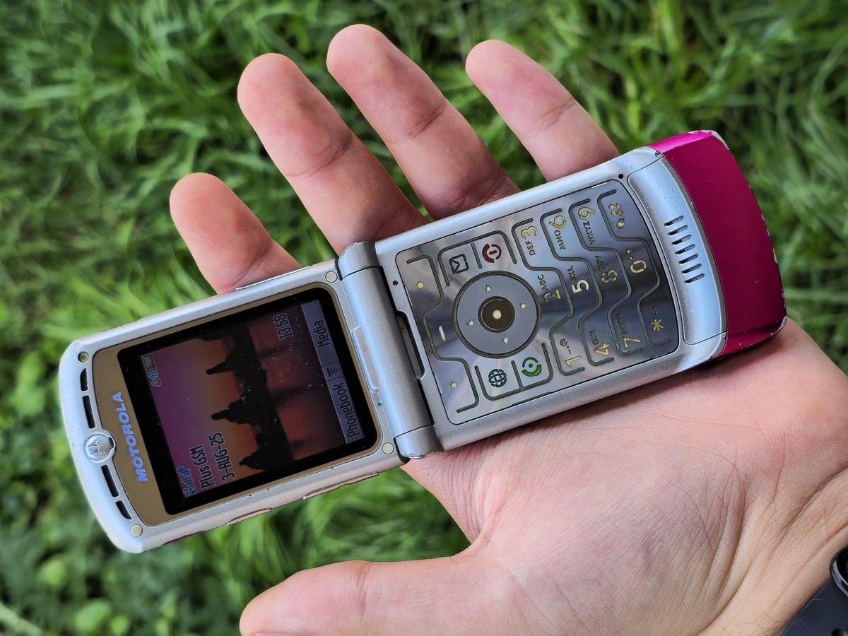 A pink Motorola RAZR V3 flip phone, open